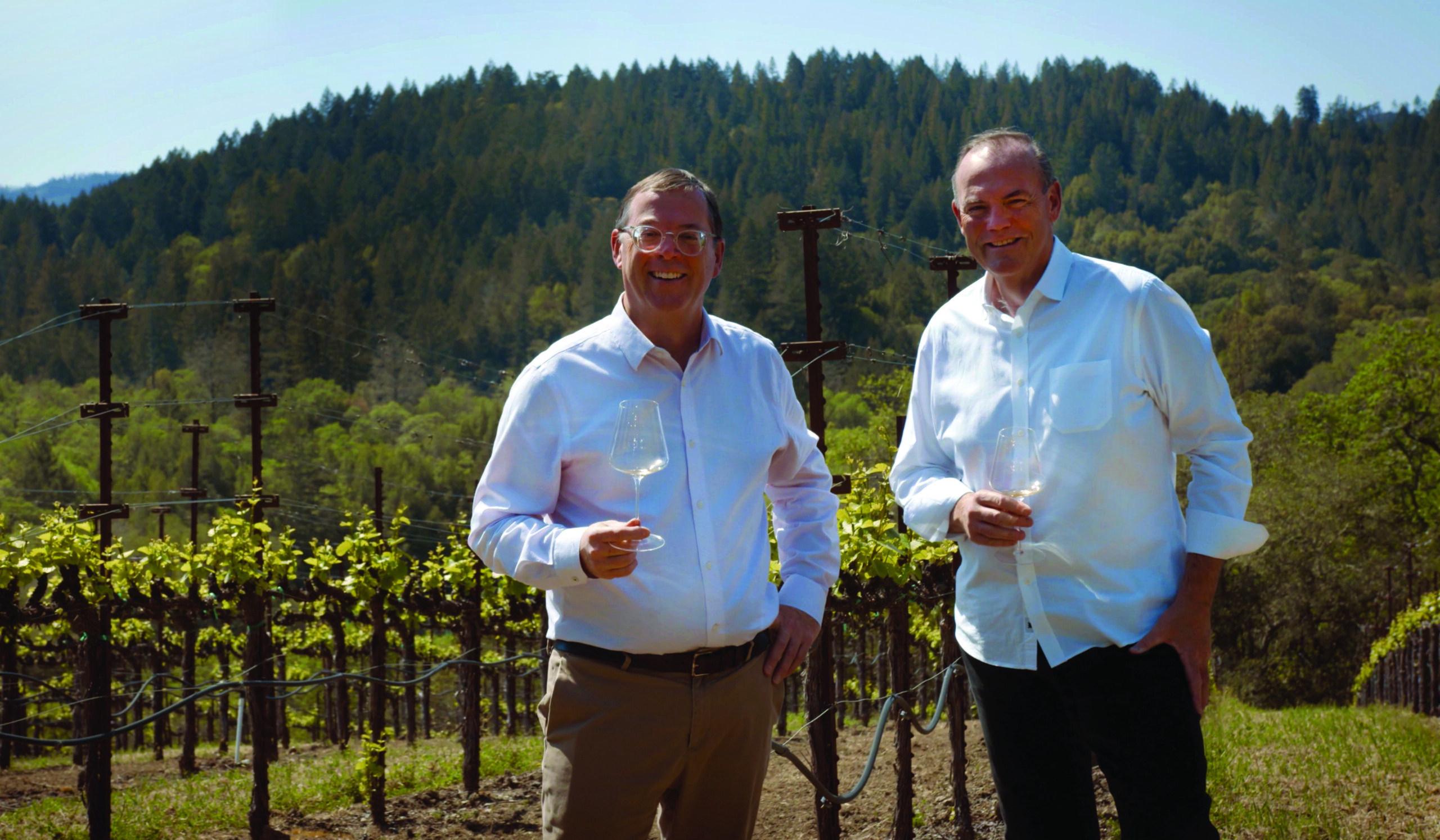 two men holding glasses of wine