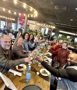 People raises glasses in restaurant